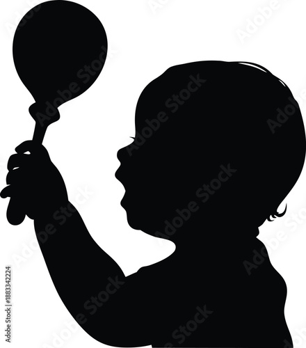 Sweet baby profile playing with a musical rattle showcasing early childhood development and infant joy