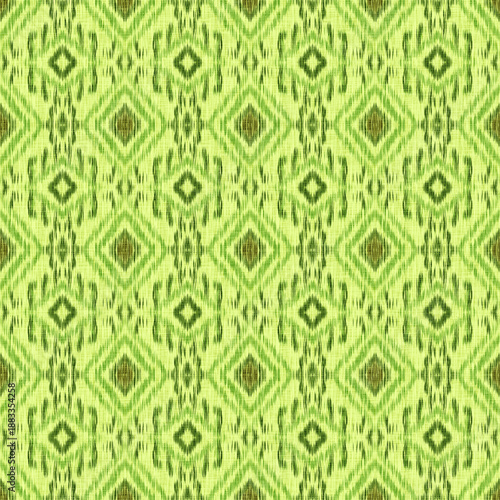 Photos Green ethnic ikat seamless pattern with symmetrical geometric motif, traditional