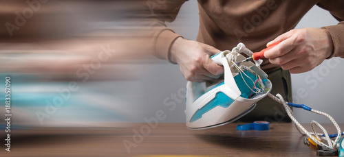 Caucasian man repairing broken iron. Iron repair