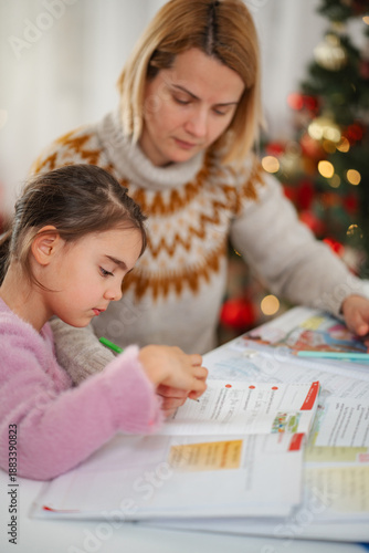 Wallpaper Mural Mother helping daughter with homework near Christmas tree Torontodigital.ca