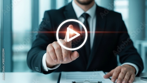 Businessman's finger points to a glowing play button, symbolizing video, media, and digital content.