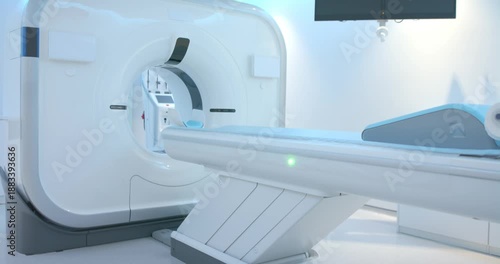 Motorized CT table is advancing slowly into gantry after start to align headrest, LED glowing