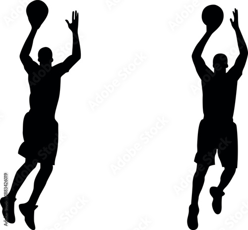 Silhouette of two basketball players jumping to shoot the ball upward