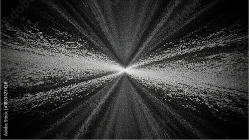 A bright light shines through the darkness, casting rays on the road ahead from a low angle viewpoint