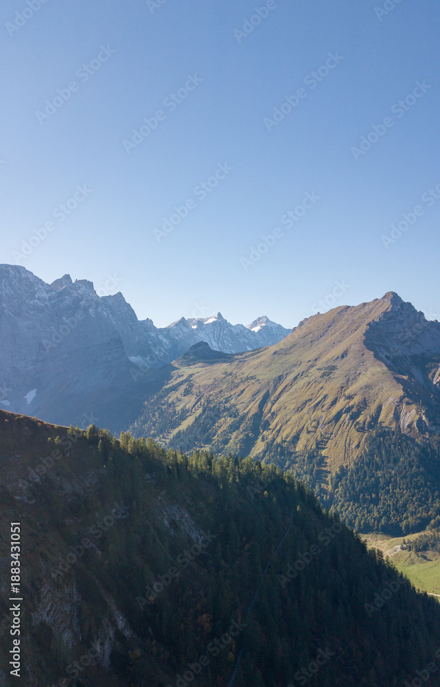 Naklejka premium Aerial Mountain Landscape with Autumn Forest and Clear Blue Sky, Großer Ahornboden, Austria