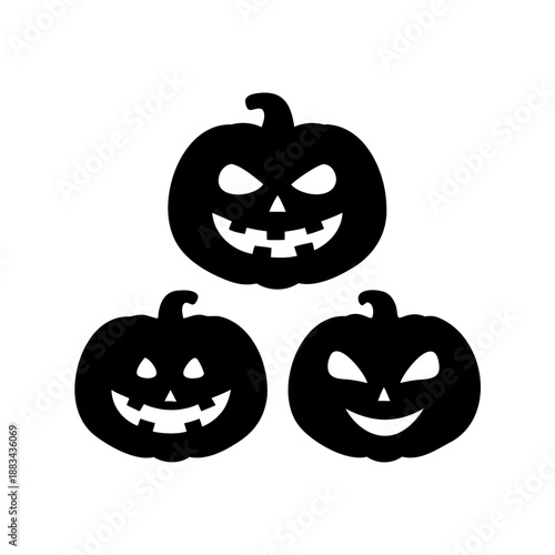 Three spooky Halloween pumpkins glowing in the darkness with menacing smiles
