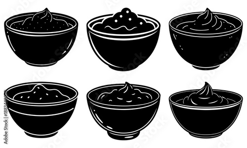 Six black bowls with whipped cream on a white background