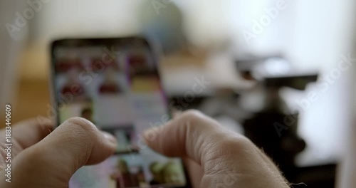 Man flipping through mobile phone. High quality 4k footage
