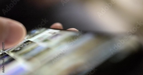Man flipping through mobile phone. High quality 4k footage