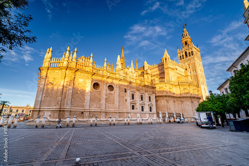 Gothic Cathedral of Our Lady of Seville with Giralda Tower at sunrise, Andalusia, Spain.