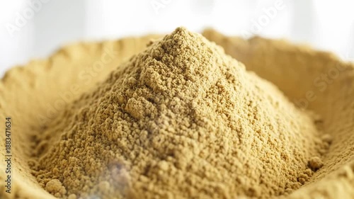 Pile of fine, light brown powder, possibly a spice or ingredient.