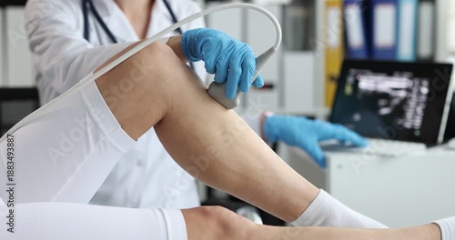 Woman doctor in gloves presses ultrasound probe to patient leg. Vascular specialist scans blood flow on monitor checking vein health at appointment