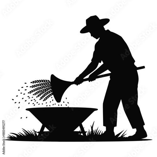 Farmer silhouette winnows grain using traditional farm methods.