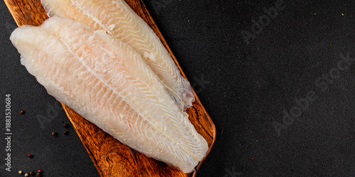 Frozen fish fillet white fish pangasius seafood tasty snack fresh delicious gourme pescetarian diet food background on the table rustic food top view copy space keto and paleo diet food