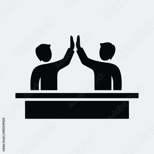 Two people giving a high five over a table silhouette vector illustration