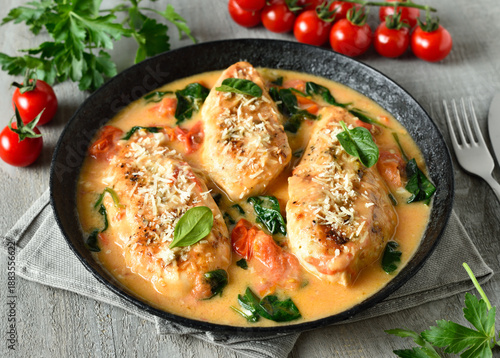 Chicken breast in creamy sauce with tomatoes and spinach