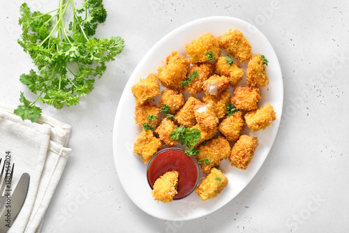 Crispy fried chicken nuggets on plate