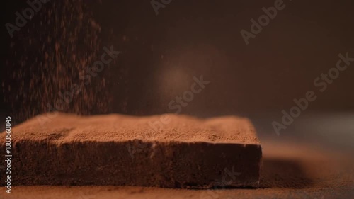 Cocoa Powder Sprinkling on Chocolate Cake in Studio Lighting