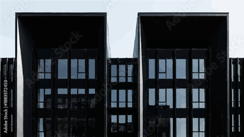 A modern dark building with tall windows and sharp lines, creating a strong and dramatic look against a bright, clear sky.