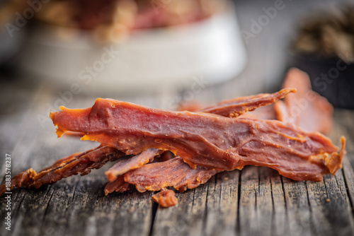 Dog food. Dried meat for dogs on wooden table.