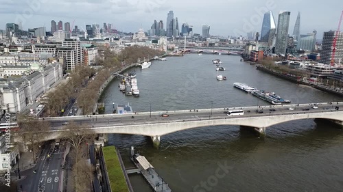 Flying over the bridge and River Thames into London cit