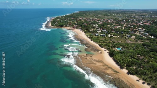 Panoramic aerial image of Três Coqueiros beach, southern coast of Bahia, Maraú Peninsula, Barra Grande, beach with coconut trees, large stretch of white sand, blue water, paradisiac