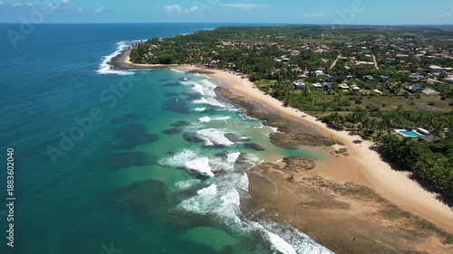 Panoramic aerial image of Três Coqueiros beach, southern coast of Bahia, Maraú Peninsula, Barra Grande, beach with coconut trees, large stretch of white sand, blue water, paradisiac
