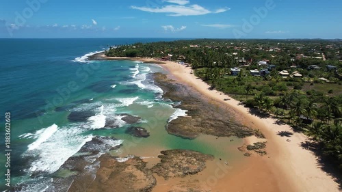 Panoramic aerial image of Três Coqueiros beach, southern coast of Bahia, Maraú Peninsula, Barra Grande, beach with coconut trees, large stretch of white sand, blue water, paradisiac