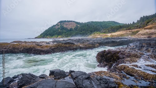 Footage capturing the powerful and dramatic waves of the Pacific Ocean crashing into the rugged basalt rock formations at Cook's Chasm and Thor's Well, near Cape Perpetua on the central Oregon Coast.