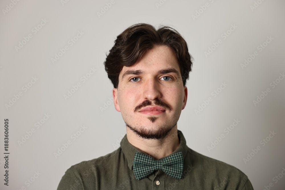 Obraz premium Handsome man with mustache on light grey background