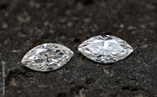 Two marquise cut diamonds on black background