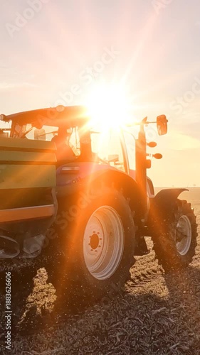 Farmer with agricultural machinery fertilizing wheat field in winter time at sunrise, slow motion. Spreading mineral fertilizer, landscape rural scene