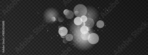 White bokeh background with shimmering light particles and soft glow effect. Magical glitter sparkles create festive atmosphere for holiday celebration and decoration designs.