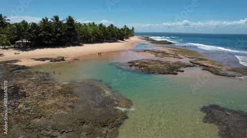 Panoramic aerial image of Três Coqueiros beach, southern coast of Bahia, Maraú Peninsula, Barra Grande, beach with coconut trees, large stretch of white sand, blue water, paradisiac