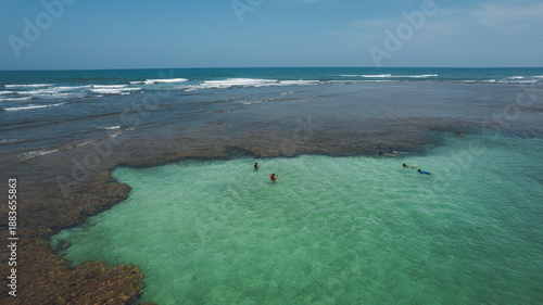 Natural pools in the sea off Taipu de Fora beach, a tourist spot on the Maraú Peninsula, coast of Bahia, Brazil, panoramic aerial view, coconut trees, blue and green sea, paradisiacal