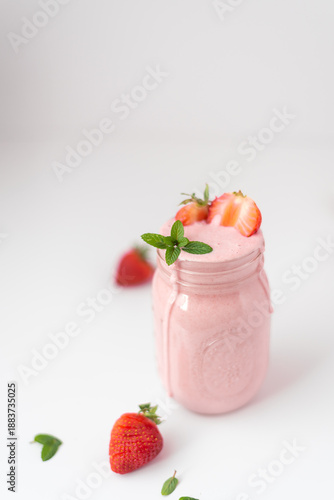 Strawberry smoothies in glasses on white background