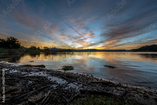 Colorful gradient horizon as the sunrise clouds reflects onto the surface of Lake Casitas