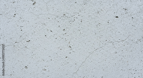 Detailed light gray concrete texture background. Seamless rough cement wall surface with fine cracks, distressed porous grunge pattern, and aged weathered architectural structure design.