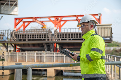 Fotografi A specialist inspector is checking the water diversion system of the wastewater treatment plant