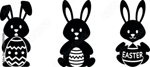Happy easter celebration with three adorable black and white easter bunnies holding decorated eggs