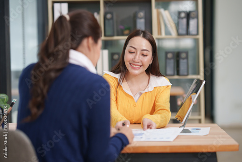 Asian business woman working and talking at the office	