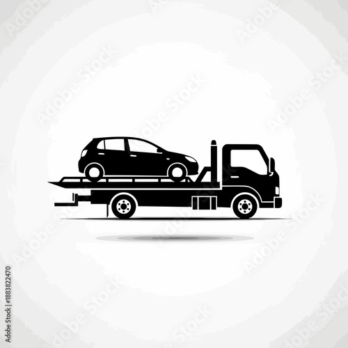 Black silhouette of a car being transported on a flatbed tow truck vehicle
