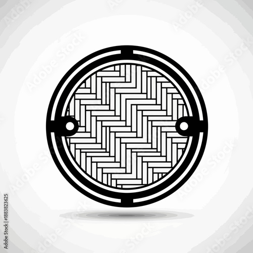 Black and white illustration of a manhole cover with a geometric pattern