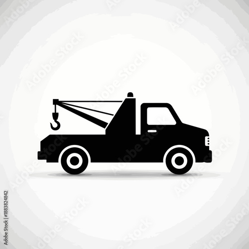 Black silhouette of a tow truck on a with gray vignette