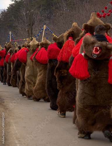 Fotografie People dancing dressed in bearskin and folk costumes at the Comanesti Customs an