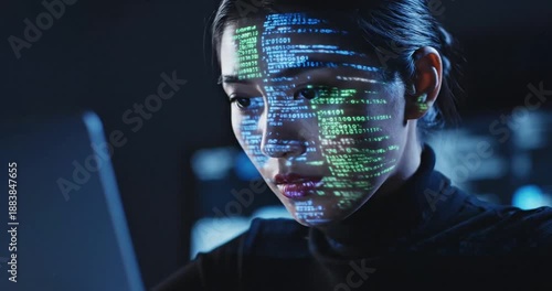 Woman using computer with code.