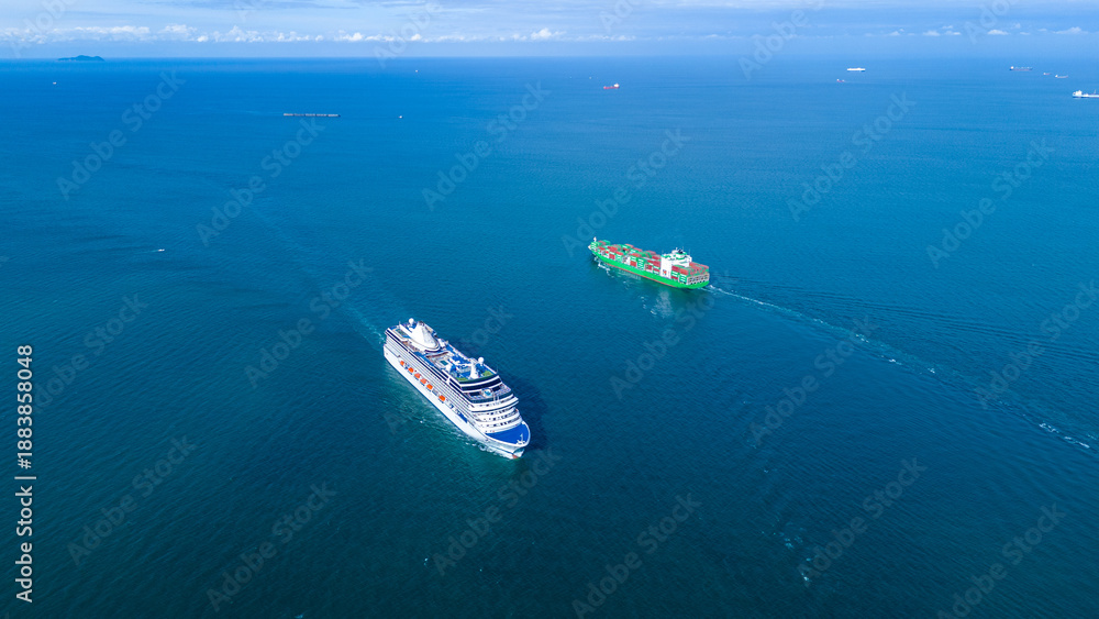 Naklejka premium a large luxury cruise ship sailing in the deep blue ocean. White passenger vessel featuring swimming pools on the top deck. Summer vacation and international tourism concept.