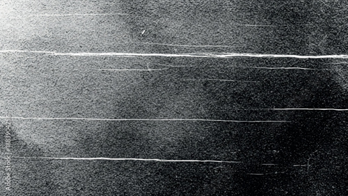 Grainy textured monochrome abstract background with horizontal scratch lines and dark gradient transition