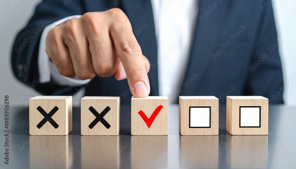 Obraz premium Hand pointing at red check mark block