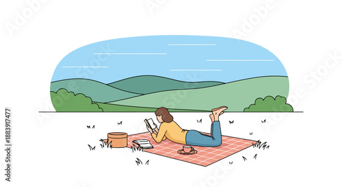 Woman relaxing on picnic blanket outdoors reading a book with phone and basket nearby enjoying sunny landscape with rolling hills and blue sky